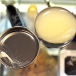 A spherical food item rests next to a metal container