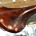 Close up view of a brown leather bicycle seat