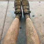 Mud-covered shoes and legs