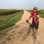 Person with bicycle on gravel road