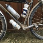 A bicycle with three water bottles attached to the frame.
