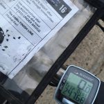 A bicycle handlebar with a route map and odometer.