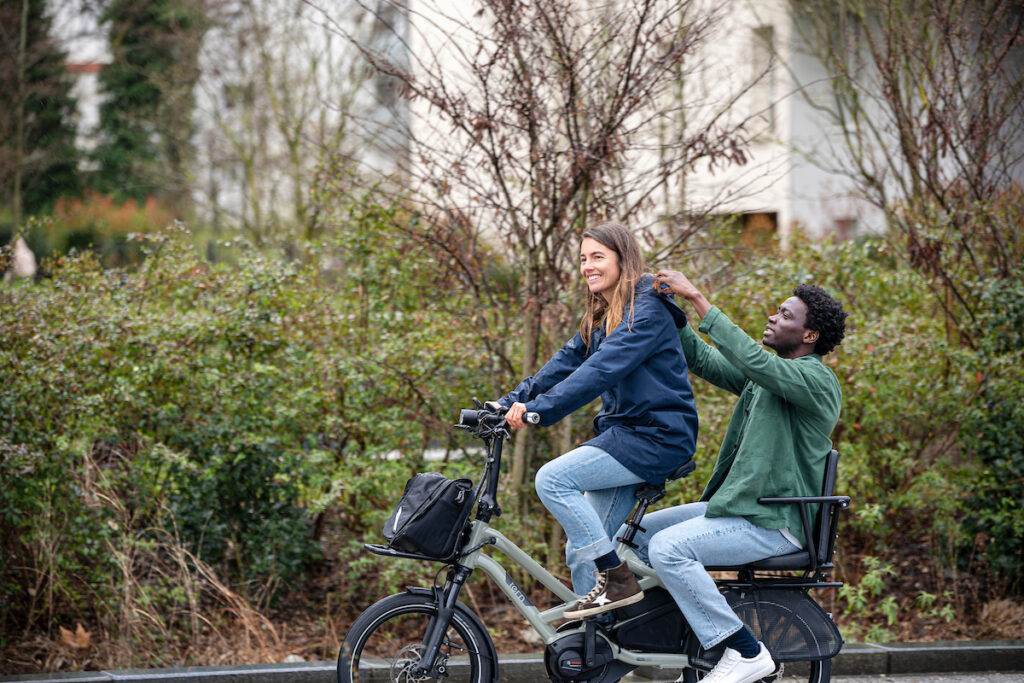 Rider pedaling the Tern HSD Gen 2 with an adult passenger