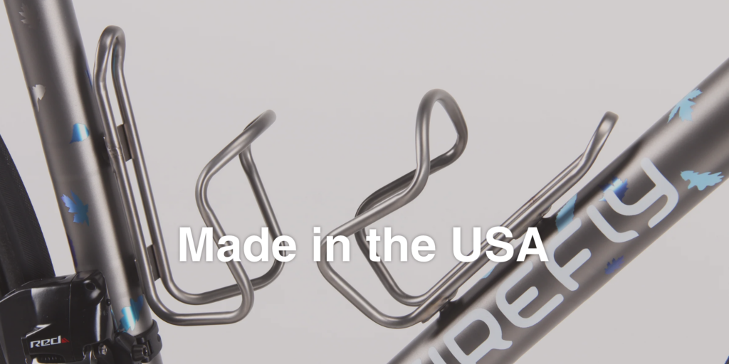 Two bottle cages on a bicycle made by King Cage, with “Made in the USA” overlaid.